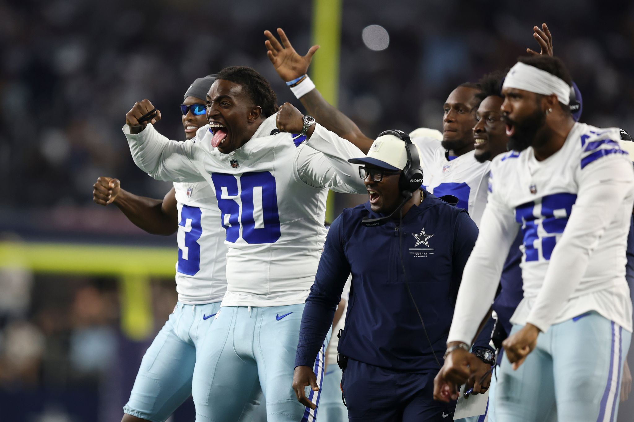 Dallas Cowboys players practicing at training camp under pressure