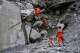 In this photo released by Xinhua News Agency, rescuers use sniffer dogs to search for victims at a mudslide-hit area in Gyirong County, southwestern China's Tibet Autonomous Region, Sunday, Aug. 30, 2026. (Jigme Dorje/Xinhua via AP)