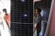 Workers carry a panel ready for installation at a solar energy systems store in Omdurman, on the outskirts of Khartoum, Sudan, July 23, 2026.