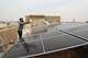 A technician cleans solar panels installed on the roof of a home in Omdurman, on the outskirts of Khartoum, Sudan, July 23, 2026.