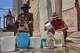 Oscar Joaquín López, left, and his housemate Wilfredo Cisneros Duarte collect water from a street pipe in Havana, Cuba, Monday, Sept. 7, 2026.