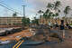 FILE: People walk past damage caused by Hurricane Lowell on Tuesday, Sept. 8, 2026, in Poipu on Kauai.