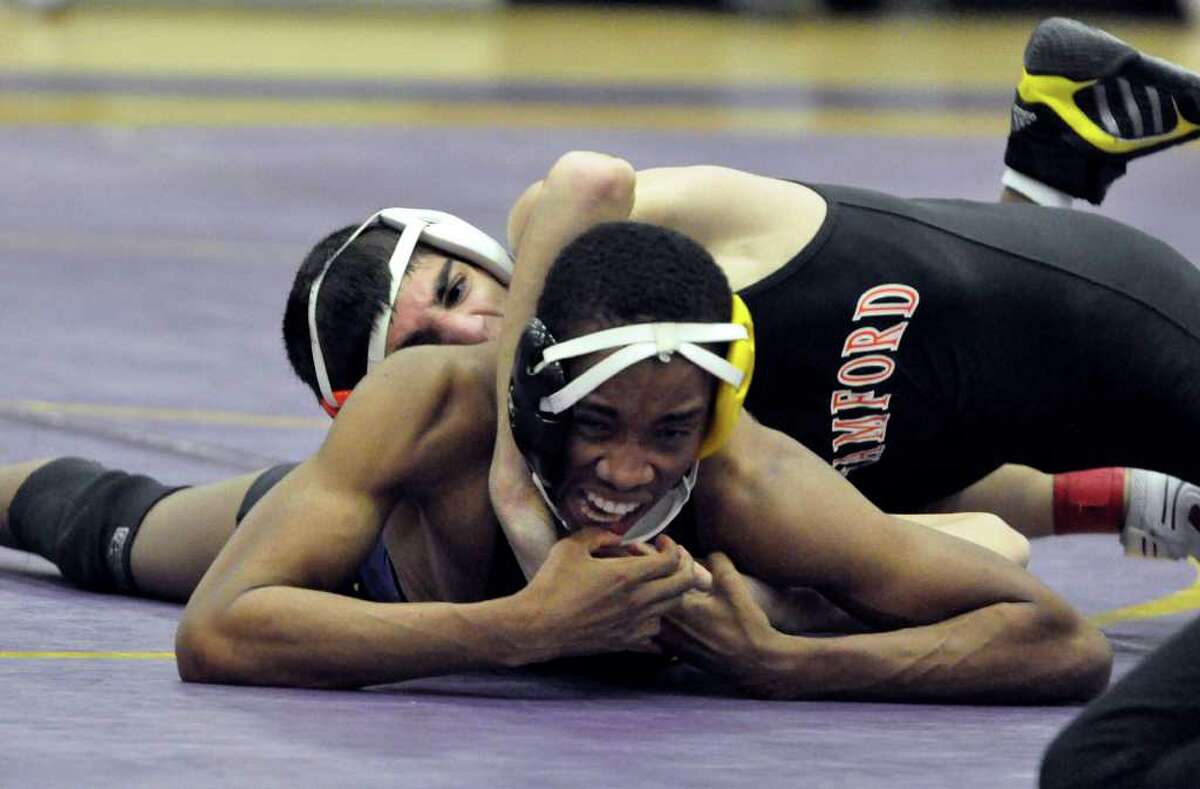 119 weight class: Westhill's Marland Hinds-Robinson tries to break out of Stamford's Joey Battinellis' hold during the boys wrestling match at Westhill on Thursday, Dec. 23, 2010.
