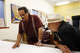 FILE: Roberto Hernandez, right, listens to Arturo Carrillo discuss plans at the offices of El Tecolote in San Francisco.