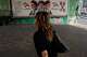 A woman walks past a banner showing portraits of the late Iranian revolutionary founder Ayatollah Khomeini, left, Supreme Leader Ayatollah Mojtaba Khamenei, center, and the late Supreme Leader Ayatollah Ali Khamenei in northern Tehran, Iran, Saturday, Sept. 12, 2026.