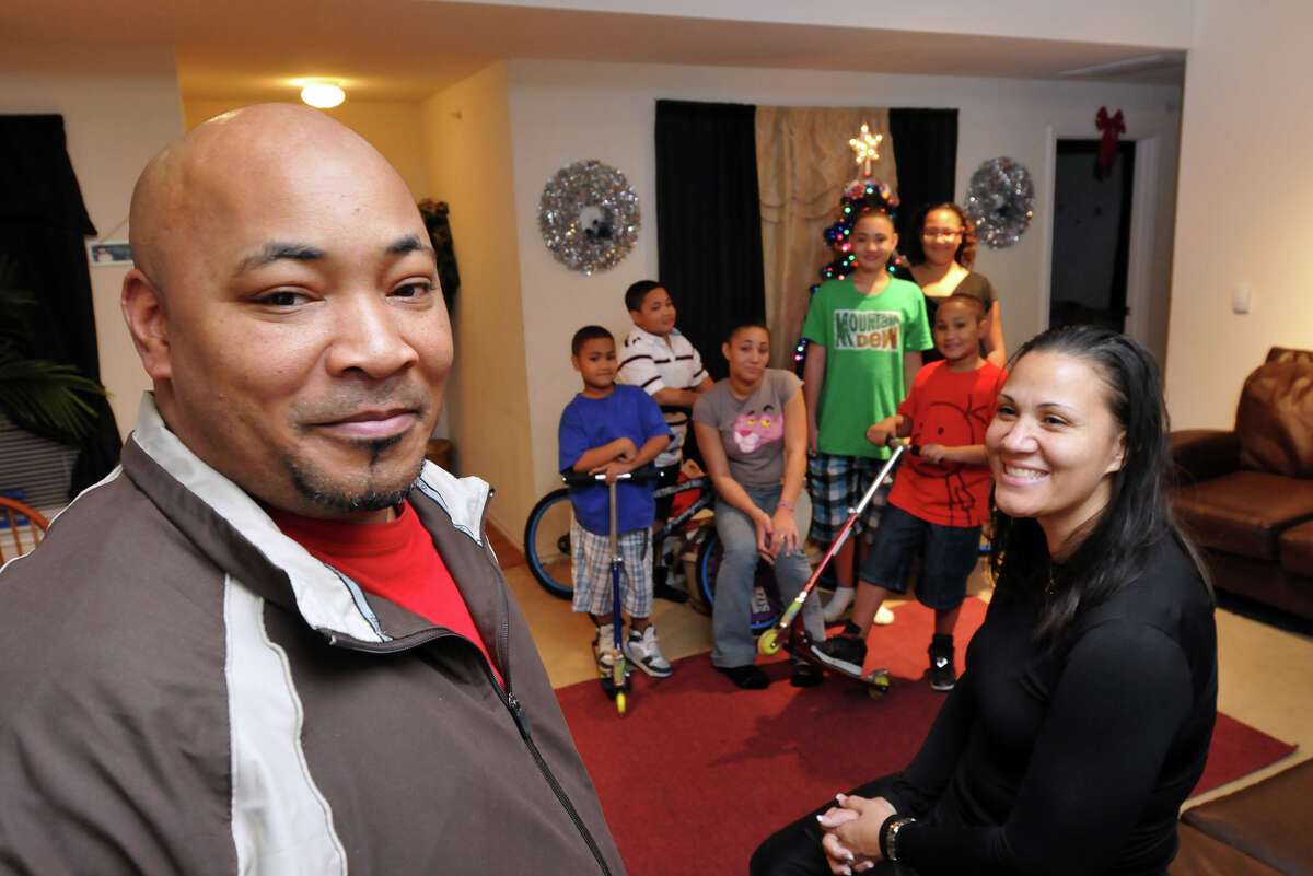 Two-time Iraq veteran Greg Easley with wife Betty and six children in their apartment, provided by Operation Homefront of Texas when they were on the verge of homelessness.