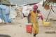 A displaced person walks through a camp in Taiz province, Yemen, Tuesday, Sept. 15, 2026.