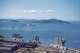 Aerial view of industrial areas and piers near the Embarcadero neighborhood of San Francisco, with the San Francisco Bay and Alcatraz Island visible, likely taken from Coit Tower, 1950. Aerial view of industrial areas and piers near the Embarcadero neighborhood of San Francisco, with the San Francisco Bay and Alcatraz Island visible, likely taken from Coit Tower, 1950.
