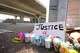 Flowers, candles and a sign reading "Justice 4 Wilber" are seen at the site where ICE agents shot Wilber Rafael Garces Perez at the intersection of Research Boulevard and Anderson Square in Austin on Monday, Sept. 21, 2026.
