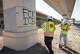 Workers with Pulice Construction paint over anti-ICE graffiti at the site where ICE agents shot Wilber Rafael Garces Perez at the intersection of Research Boulevard and Anderson Square in Austin on Monday, Sept. 21, 2026.