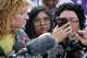 Elizdar, wife of Wilber Rafael Garces Perez, listens as her husband speaks by phone from the South Texas ICE Processing Center in Pearsall during a news conference at the Law Office of Kate Lincoln-Goldfinch in Austin on Monday, Sept. 21, 2026, about the shooting by an ICE agent the previous day.