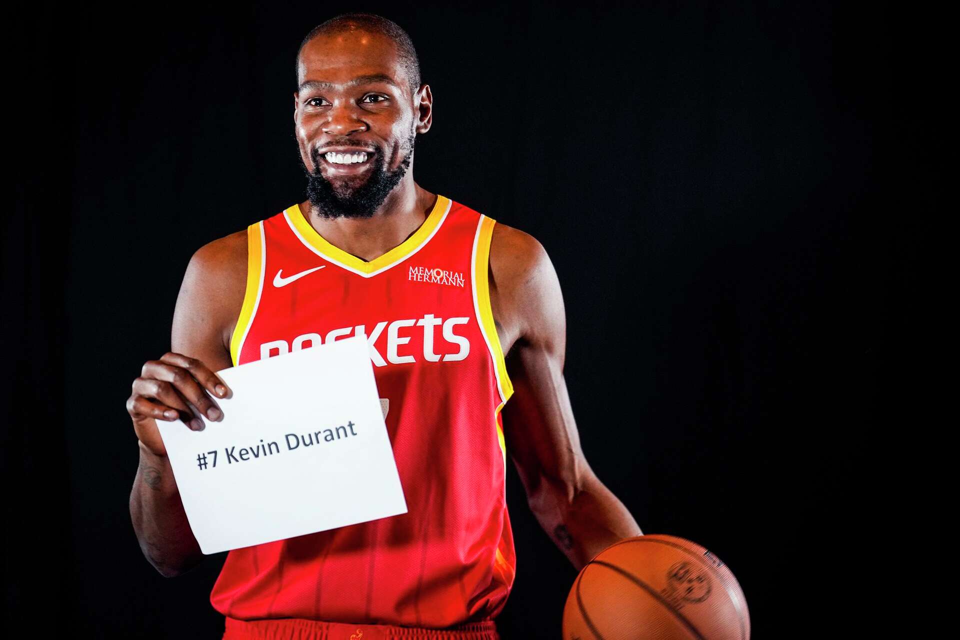 Houston Rockets forward Kevin Durant holds up an identification card while posing for photos during Rockets Media Day in Houston, Tuesday, Sept. 22, 2026.