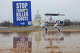 Signs are planted into the ground on the National Mall on March 6, 2026, in Washington, in protest against OpenAI’s decision to allow the Pentagon to use its AI technologies.