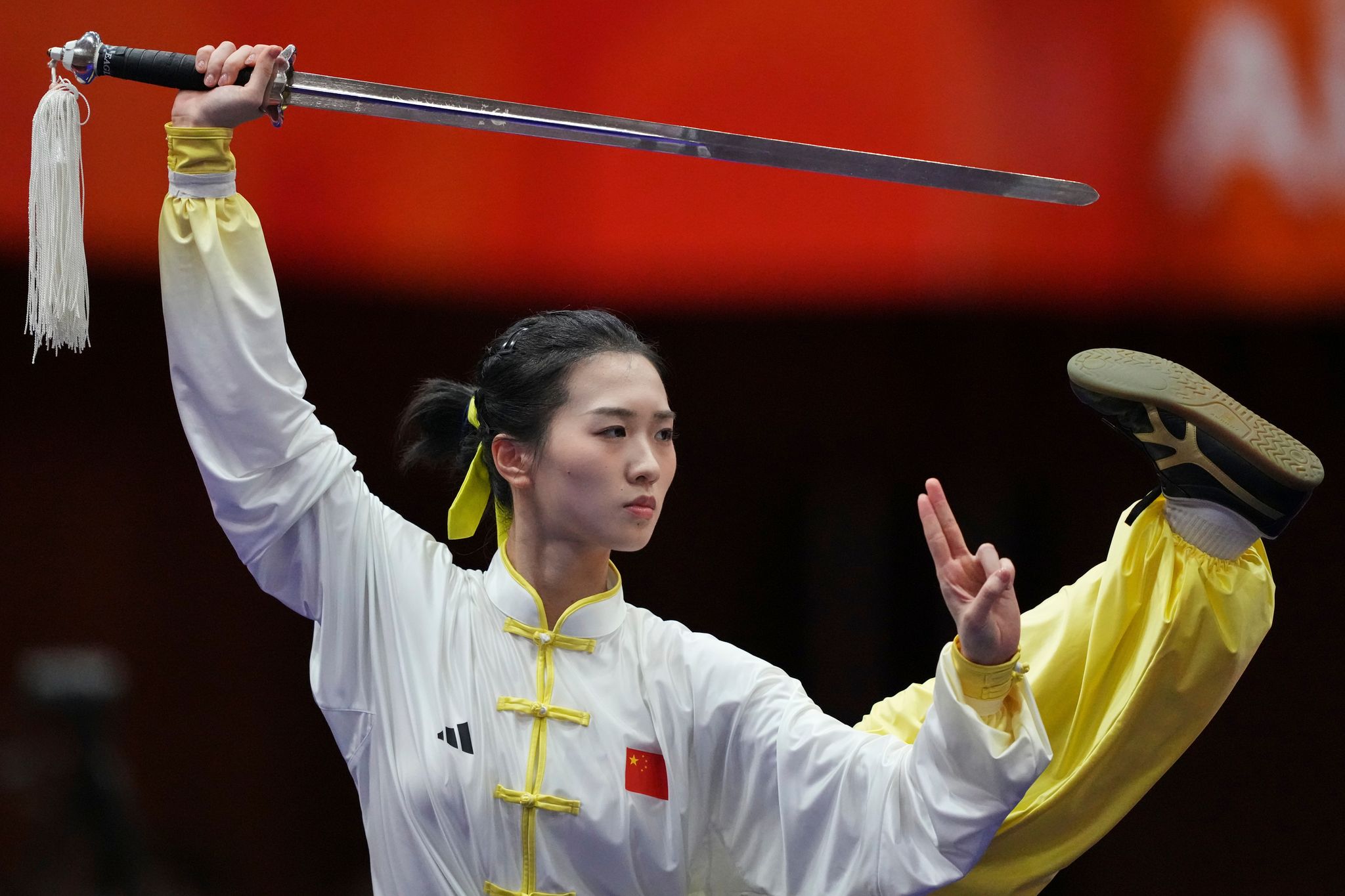 Photos of wushu athletes performing martial arts routines at the Asian ...