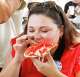 Dallas Morning News Energy & Natural Resources Reporter Lana Ferguson tries the Flamin’ Crunch Pizza during opening day of the State Fair of Texas at Fair Park in Dallas, Friday, Sept. 25, 2026.