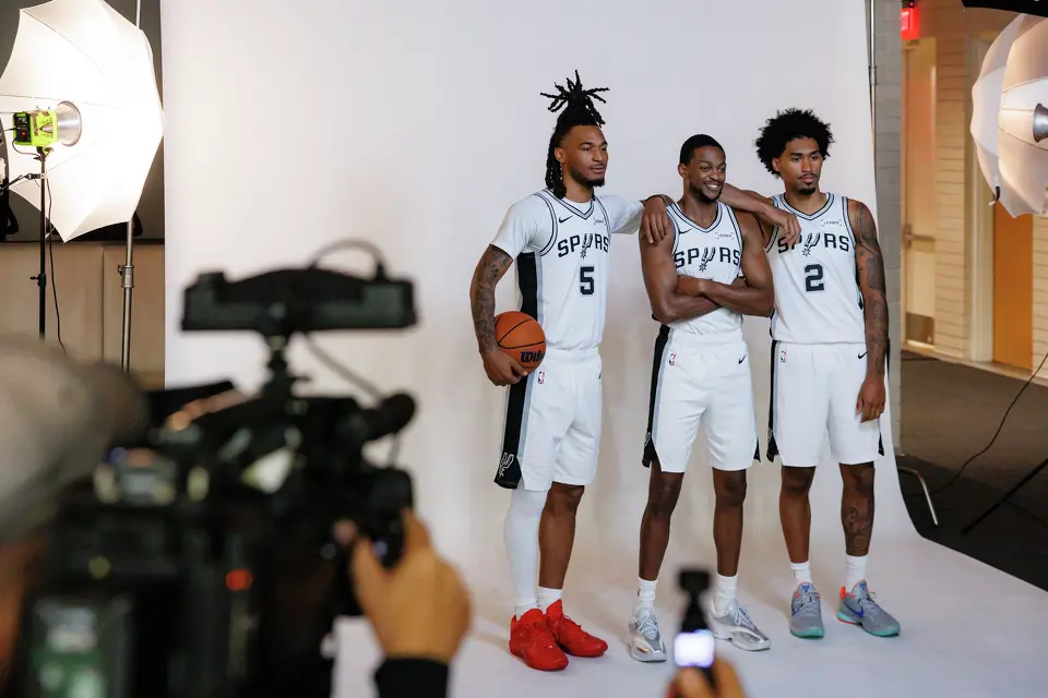 San Antonio Spurs guards Stephon Castle (5), De’Aaron Fox (4) and Dylan Harper (2) pose for photos during the NBA team’s media day at the Victory Capital Performance Center in San Antonio, Monday, Sept. 28, 2026.
