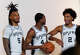 San Antonio Spurs guards Stephon Castle (5), De’Aaron Fox (4) and Dylan Harper (2) joke around after taking portraits together during the NBA basketball team’s media day at the Victory Capital Performance Center in San Antonio, Monday, Sept. 28, 2026.