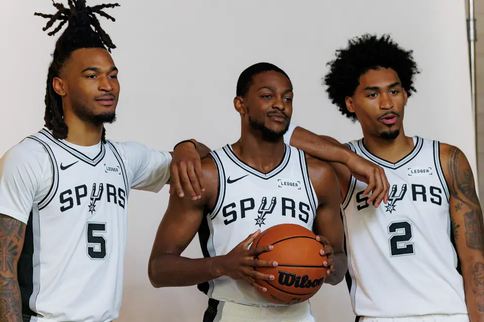 San Antonio Spurs guards Stephon Castle (5), De’Aaron Fox (4) and Dylan Harper (2) pose for official portraits together during the NBA basketball team’s media day at the Victory Capital Performance Center in San Antonio, Monday, Sept. 28, 2026.