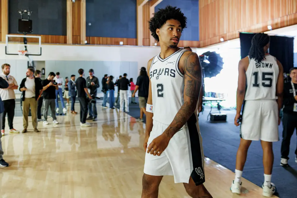 San Antonio Spurs guard Dylan Harper (2) walks through the gymnasium on his way to another interview during the NBA team’s media day at the Victory Capital Performance Center in San Antonio, Monday, Sept. 28, 2026.