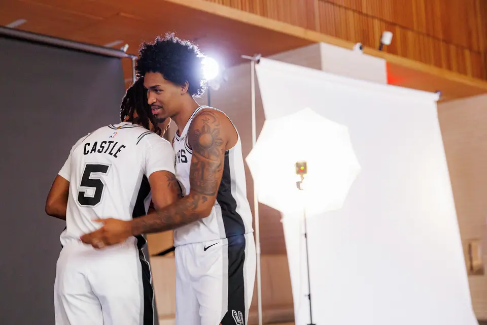 San Antonio Spurs guards Stephon Castle (5) and Dylan Harper (2) embrace as they have their photographs taken during the NBA basketball team’s media day at the Victory Capital Performance Center in San Antonio, Monday, Sept. 28, 2026.