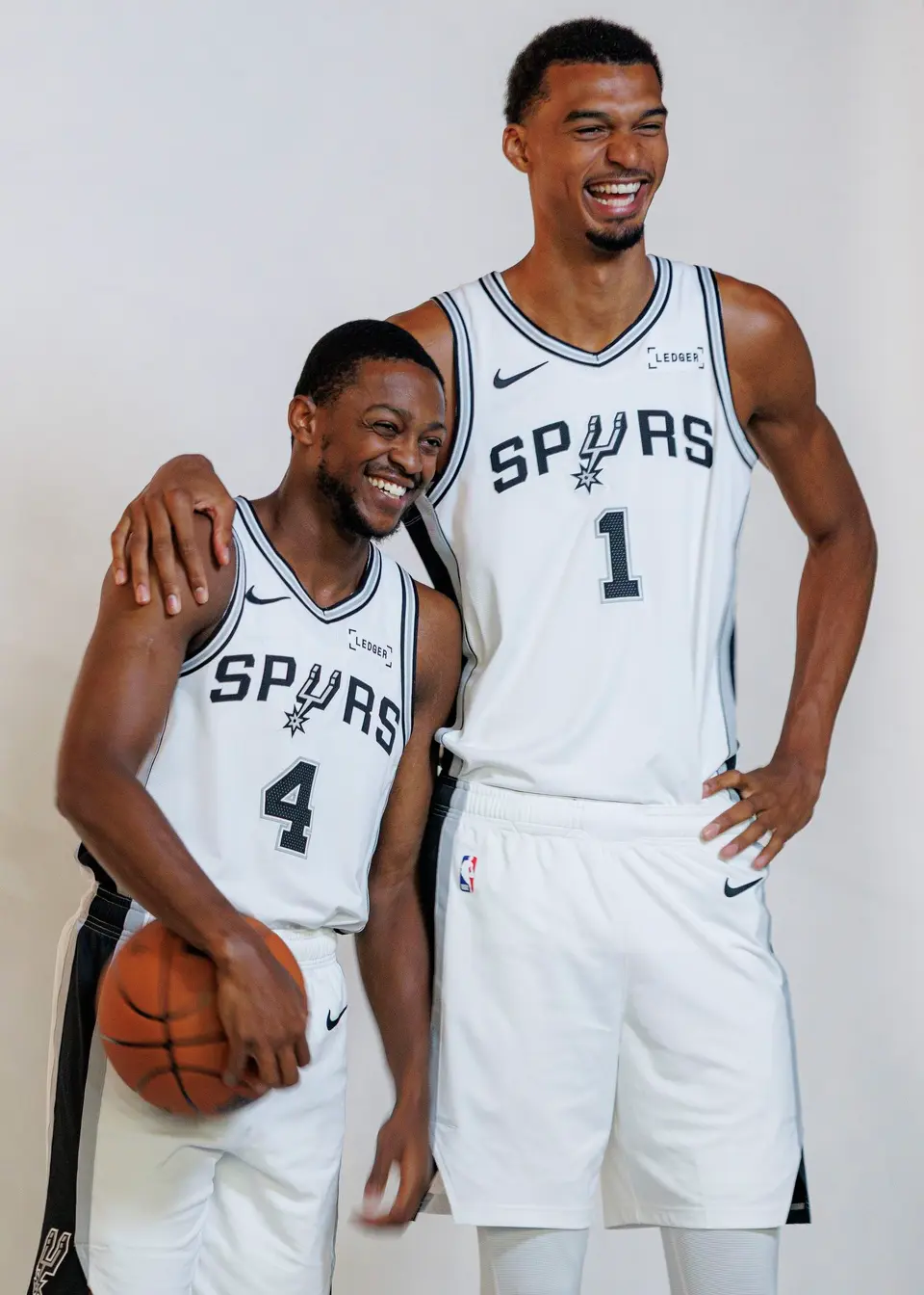 San Antonio Spurs’ De'aaron Fox (4) and Victor Wembanyama (1) pose for photos together during the NBA basketball team’s media day at the Victory Capital Performance Center in San Antonio, Monday, Sept. 28, 2026.