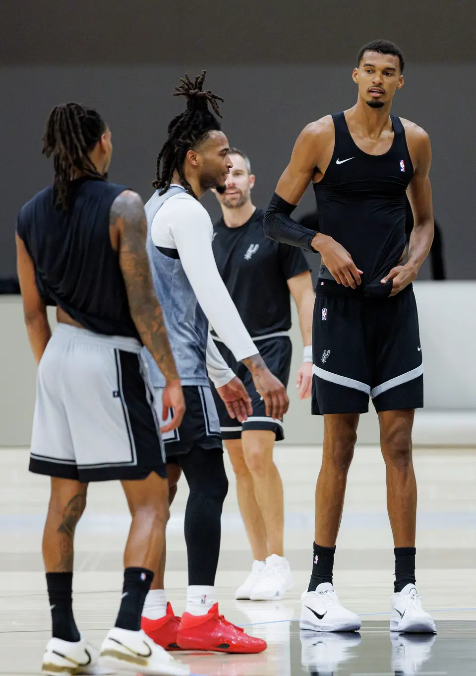 San Antonio Spurs players Devin Vassell, from left, Stephon Castle and Victor Wembanyama participate in training camp at Victory Capital Performance Center in San Antonio, Tuesday, Sept. 29, 2026.