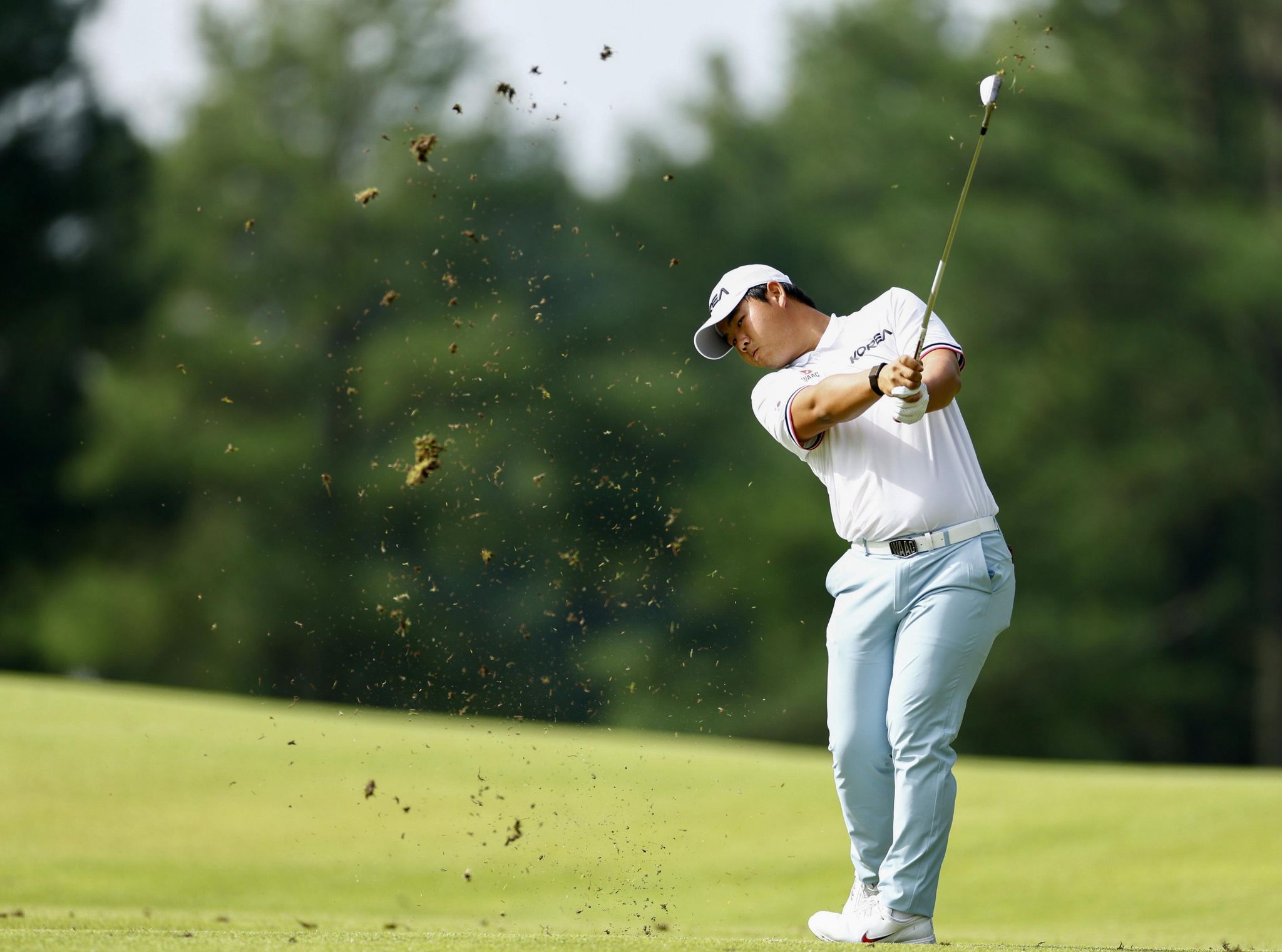 Tom Kim plays from the fairway at the 2026 Asian Games