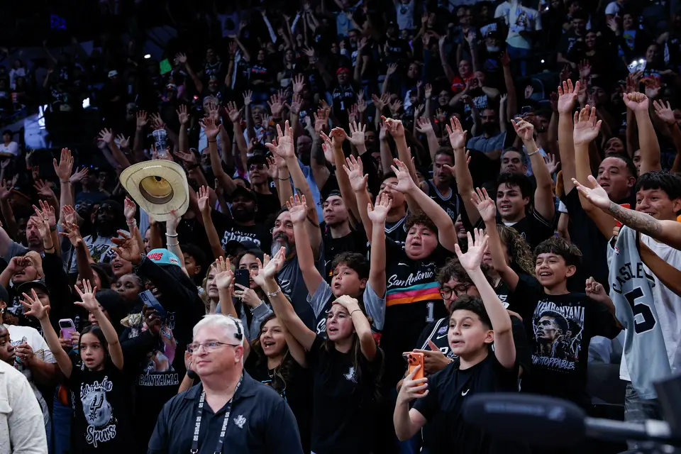 San Antonio Spurs fans wave their hands in the air in hopes of getting signed merchandise from players after watching the Silver & Black Scrimmage at Frost Bank Center in San Antonio, Sunday, Oct. 4, 2026.
