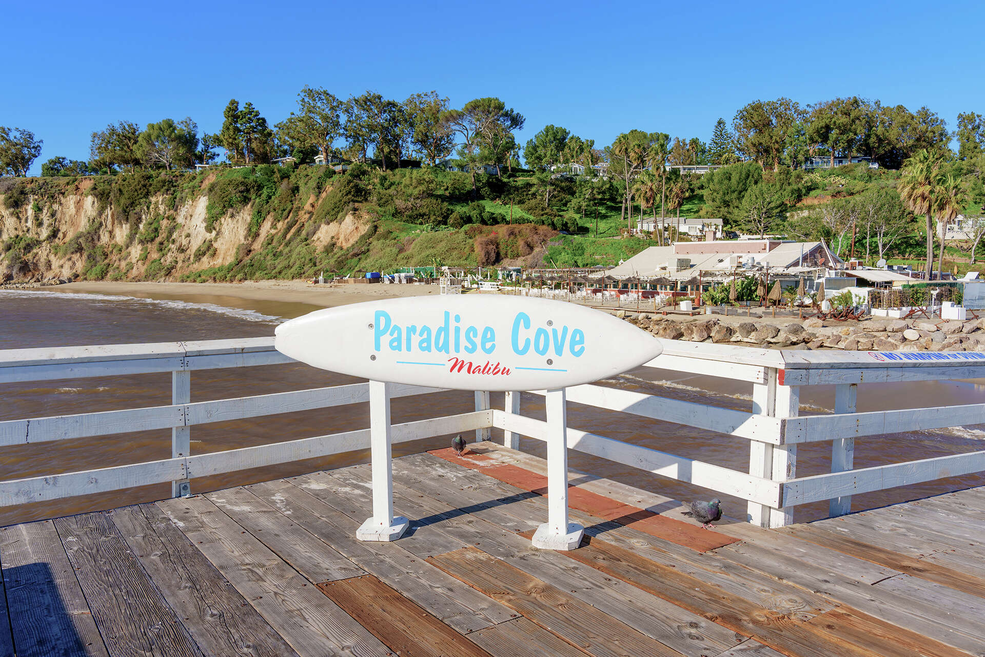 View of the “Paradise Cove, Malibu” sign on the pier in Malibu, Calif., Jan. 31, 2023.