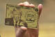 U.S. President Donald Trump holds up a “Trump Gold Card” as he makes an announcement from the Roosevelt Room of the White House in Washington, D.C., on Dec. 19, 2025.
