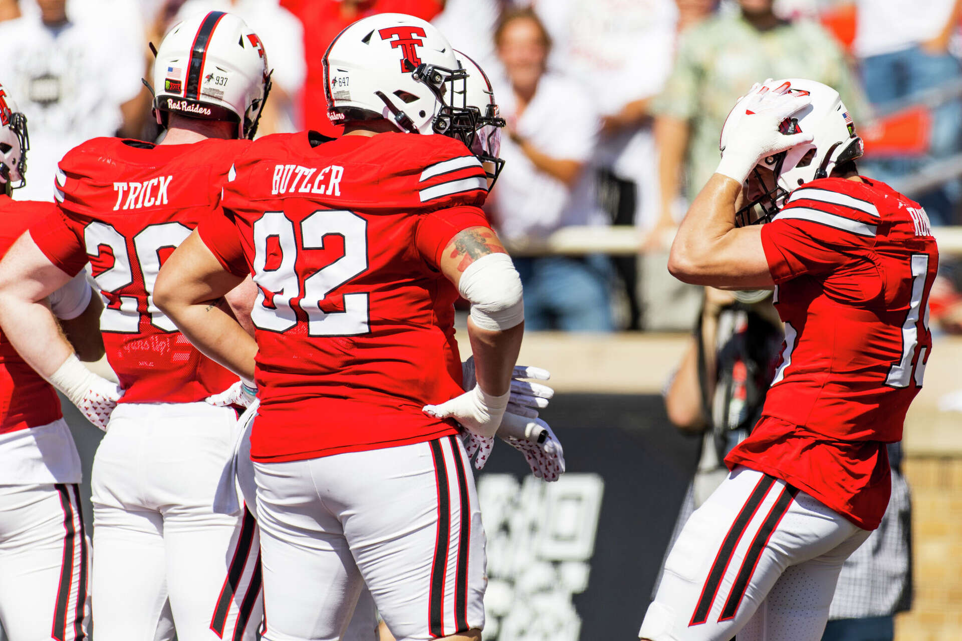 LUBBOCK, TEXAS - SEPTEMBER 26: Austin Romaine #15 of the Texas Tech Red Raiders celebrates with teammates after returning an interception for a touchdown during