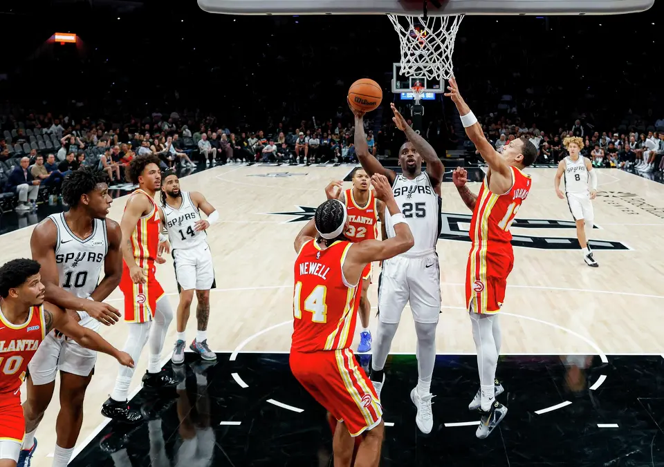 San Antonio Spurs guard David Jones Garcia (25) goes up for a shot through a sea of Atlanta Hawks defenders during the fourth quarter at Frost Bank Center in San Antonio, Thursday, Oct. 8, 2026. The Spurs fell 123-116 to the Hawks in the preseason opener.