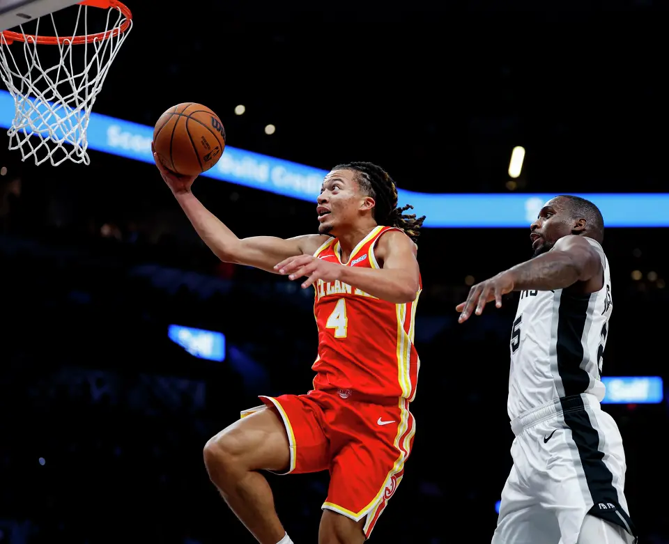 Atlanta Hawks guard Kingston Flemings (4) gets past San Antonio Spurs guard David Jones Garcia (25) to make a layup during the fourth quarter at Frost Bank Center in San Antonio, Thursday, Oct. 8, 2026. The Spurs fell 123-116 to the Hawks in the preseason opener.