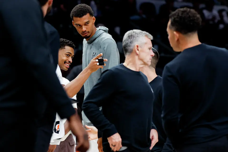 San Antonio Spurs’ Keldon Johnson and Victor Wembanyama talk during a timeout in the preseason opener against the Atlanta Hawks at Frost Bank Center in San Antonio, Thursday, Oct. 8, 2026.