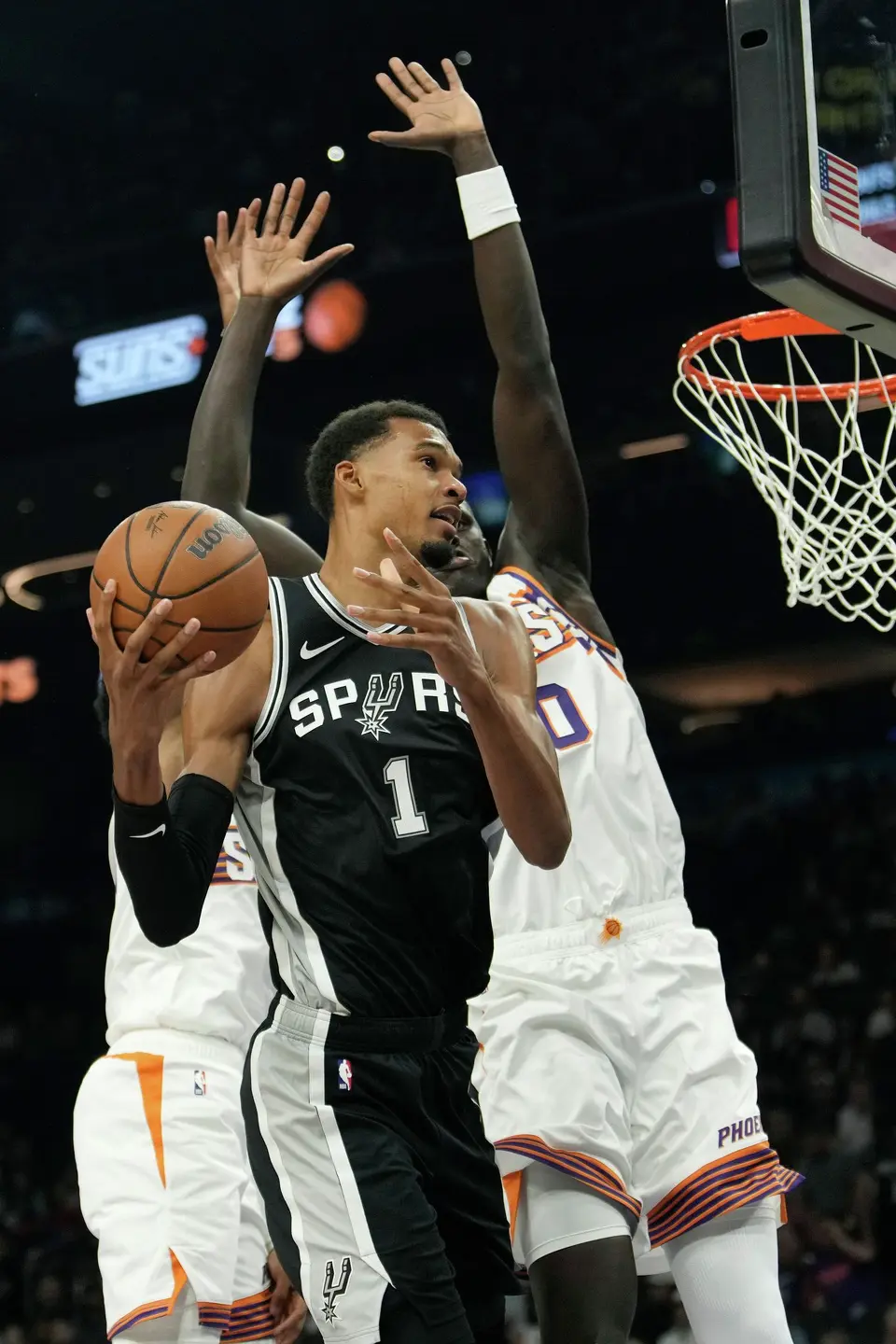 San Antonio Spurs forward Victor Wembanyama (1) goes up for a shot against the Phoenix Suns during a preseason NBA basketball game, Saturday, Oct. 10, 2026, in Phoenix. (AP Photo/Ross D. Franklin)