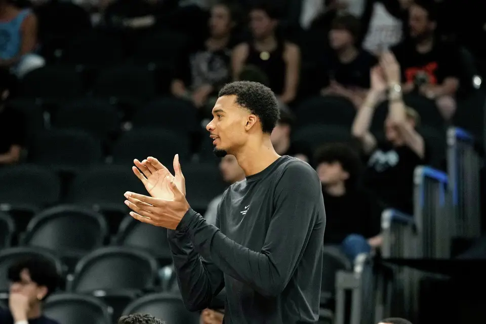 San Antonio Spurs forward Victor Wembanyama applauds a score against the Phoenix Suns during a preseason NBA basketball game, Saturday, Oct. 10, 2026, in Phoenix. (AP Photo/Ross D. Franklin)