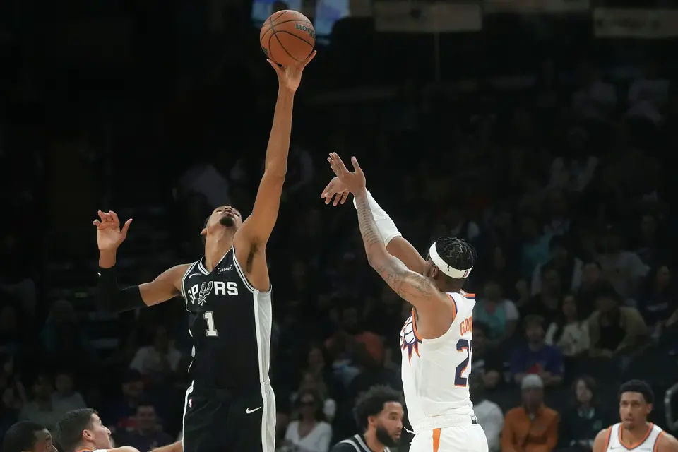 San Antonio Spurs forward Victor Wembanyama (1) blocks a 3-point shot by Phoenix Suns guard Jordan Goodwin, right, during a preseason NBA basketball game, Saturday, Oct. 10, 2026, in Phoenix. (AP Photo/Ross D. Franklin)