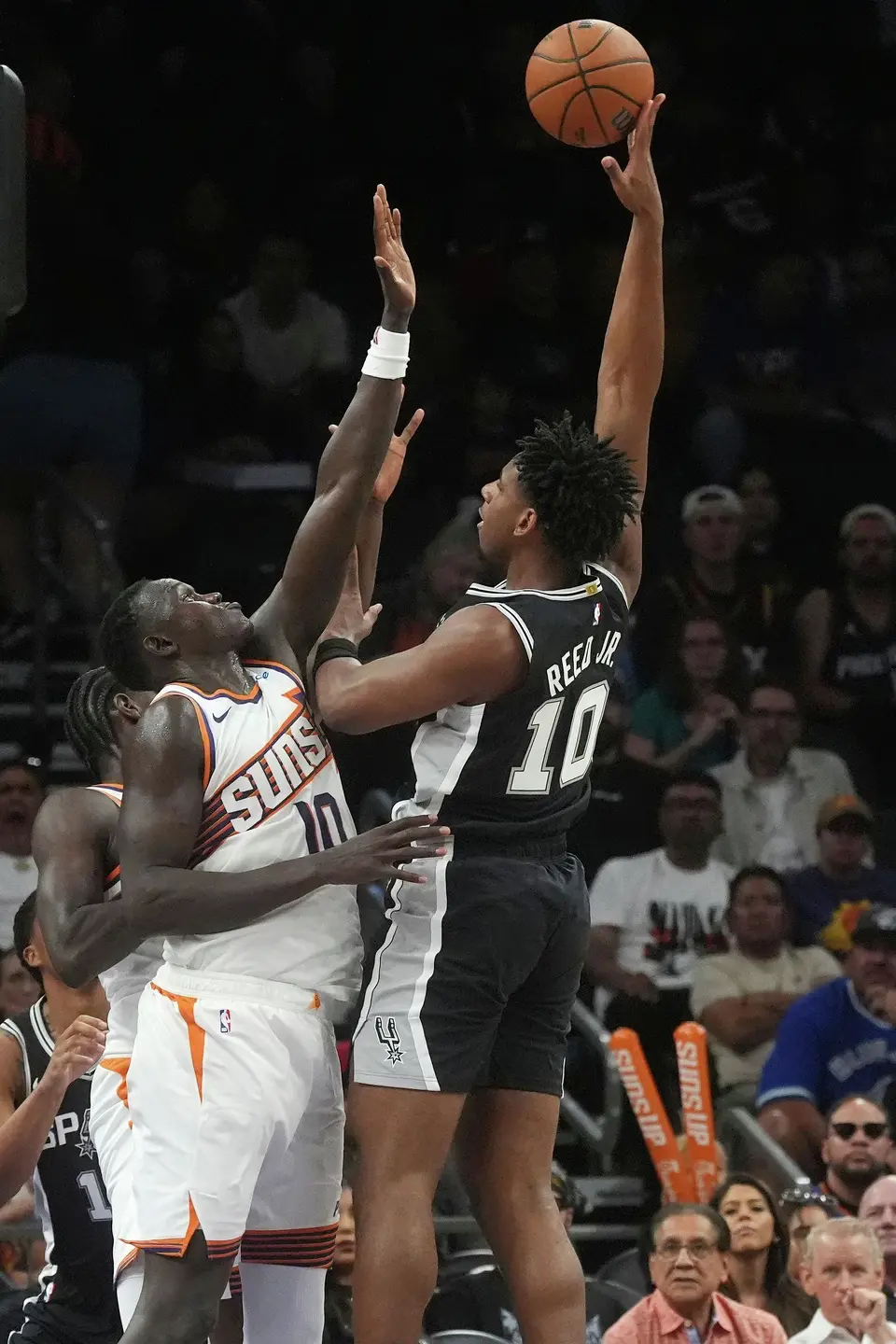 San Antonio Spurs center Tarris Reed Jr. (10) shoots over Phoenix Suns center Khaman Maluach, left, during a preseason NBA basketball game, Saturday, Oct. 10, 2026, in Phoenix. (AP Photo/Ross D. Franklin)