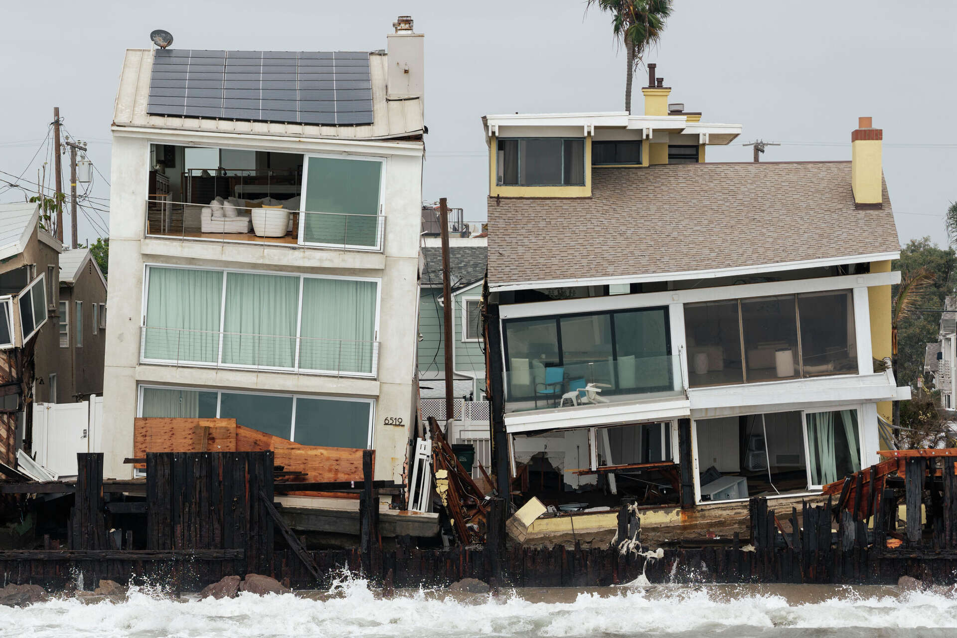 Homes teeter in Long Beach last Sunday in the aftermath of Tropical Storm Rachel. Storms like Rachel rarely make it to shore in Southern California.