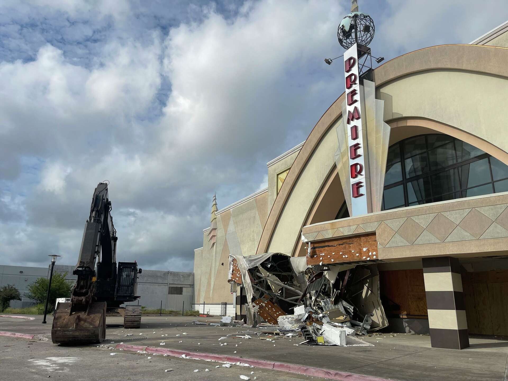 A bulldozer is parked next to the Premiere Renaissance 15 theater at Greenspoint Mall as demolition to the property began on October 13, 2026.