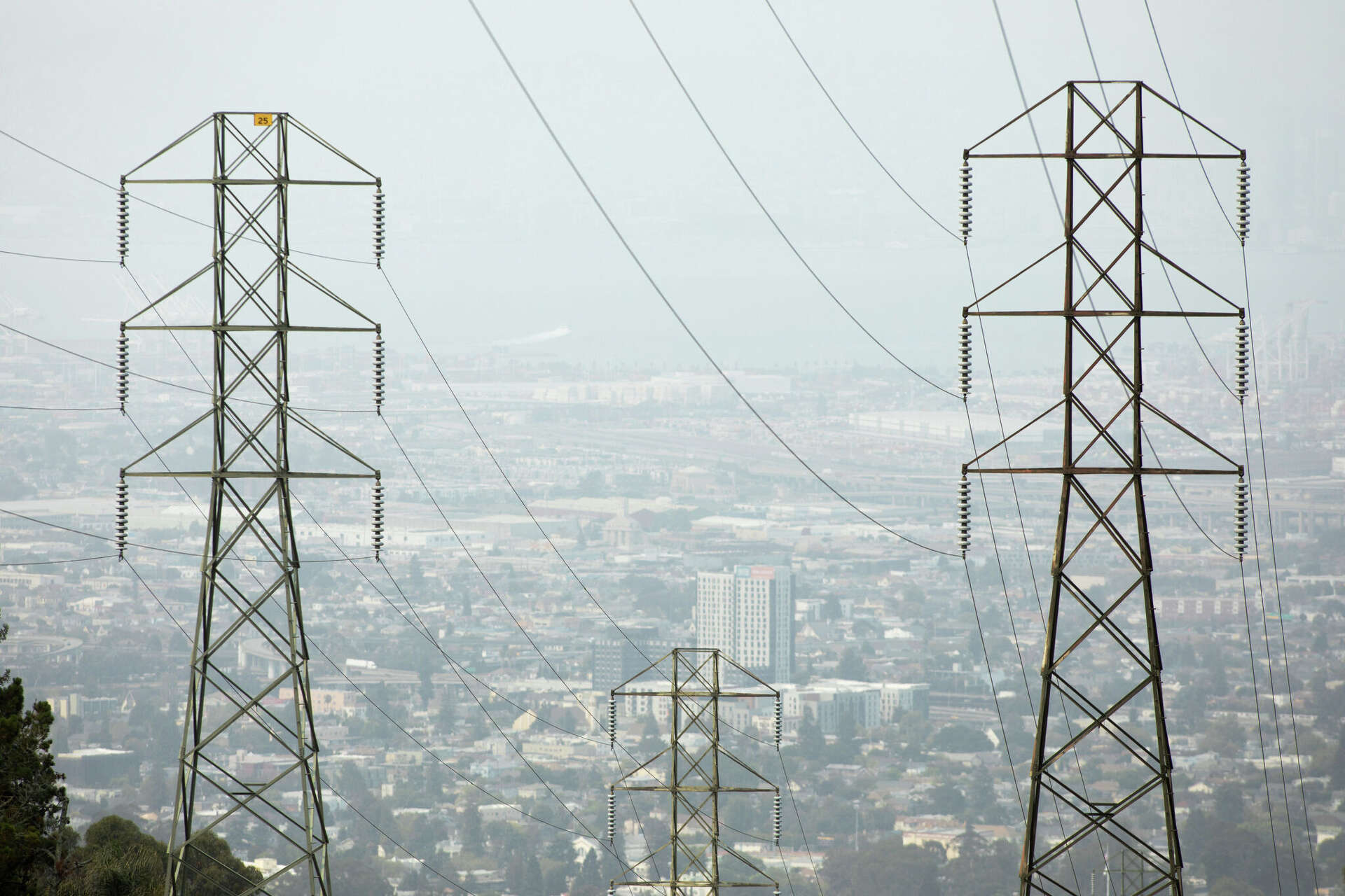 FILE: Transmission power lines stretch over the hills in Oakland, Calif.