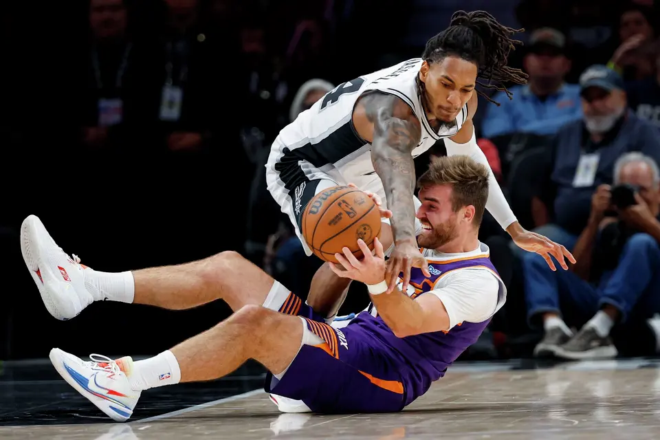 San Antonio Spurs forward Devin Vassell (24) guards Phoenix Suns guard Pat Spencer (61) during the first half of a preseason NBA game at Frost Bank Center in San Antonio, Wednesday, Oct. 14, 2026.
