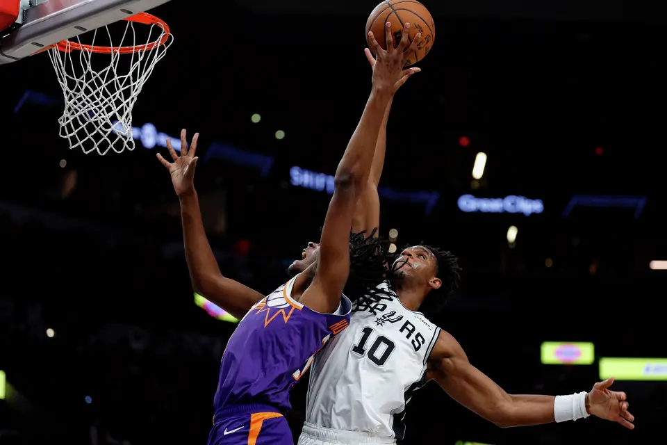 San Antonio Spurs center Tarris Reed Jr. (10) blocks a shot by Phoenix Suns forward CJ Huntley (21) during the second half of a preseason NBA game at Frost Bank Center in San Antonio, Wednesday, Oct. 14, 2026. The Spurs defeated the Suns 123-103.