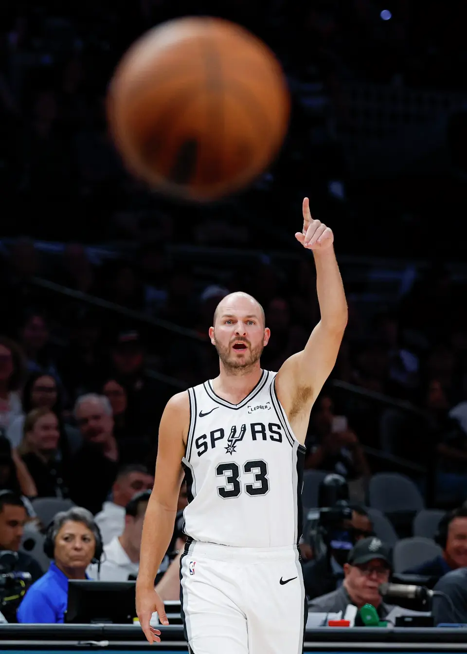 San Antonio Spurs guard Jon Elmore (33) signals to his teammate Tarris Reed Jr. (10) during the second half of a preseason NBA game against the Phoenix Suns at Frost Bank Center in San Antonio, Wednesday, Oct. 14, 2026. The Spurs defeated the Suns 123-103.