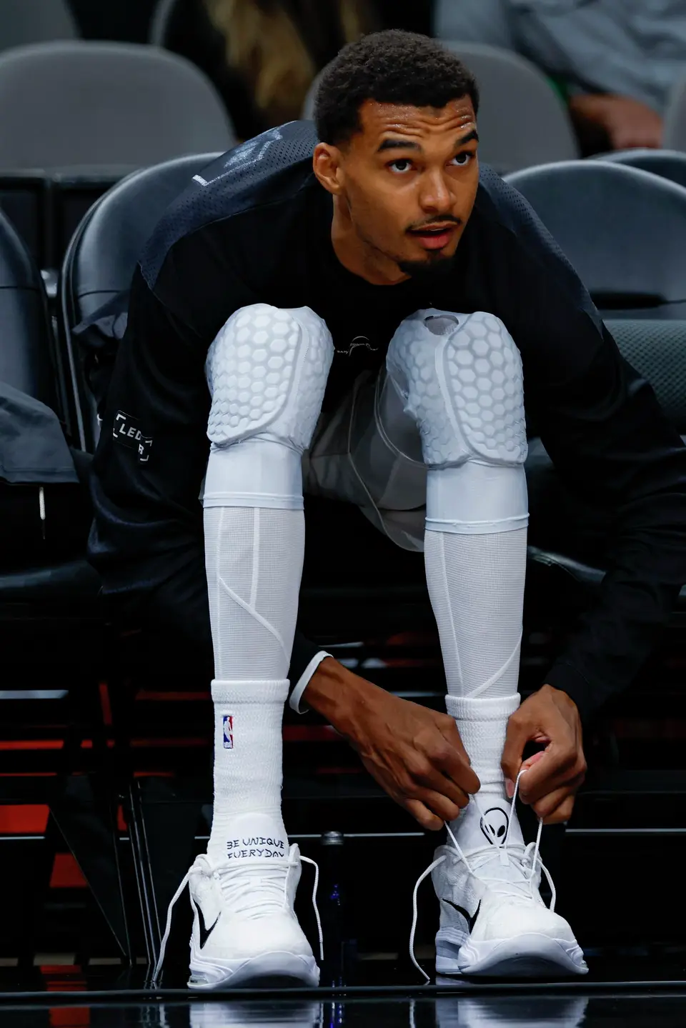 San Antonio Spurs center Victor Wembanyama (1) puts on a fresh pair of shoes before taking on the Phoenix Suns in a preseason NBA game at Frost Bank Center in San Antonio, Wednesday, Oct. 14, 2026.