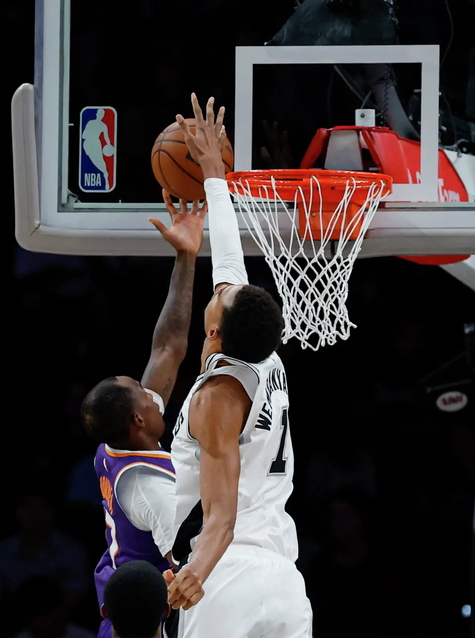San Antonio Spurs center Victor Wembanyama (1) blocks Phoenix Suns guard Jamaree Bouyea (17) during the first half of a preseason NBA game at Frost Bank Center in San Antonio, Wednesday, Oct. 14, 2026.