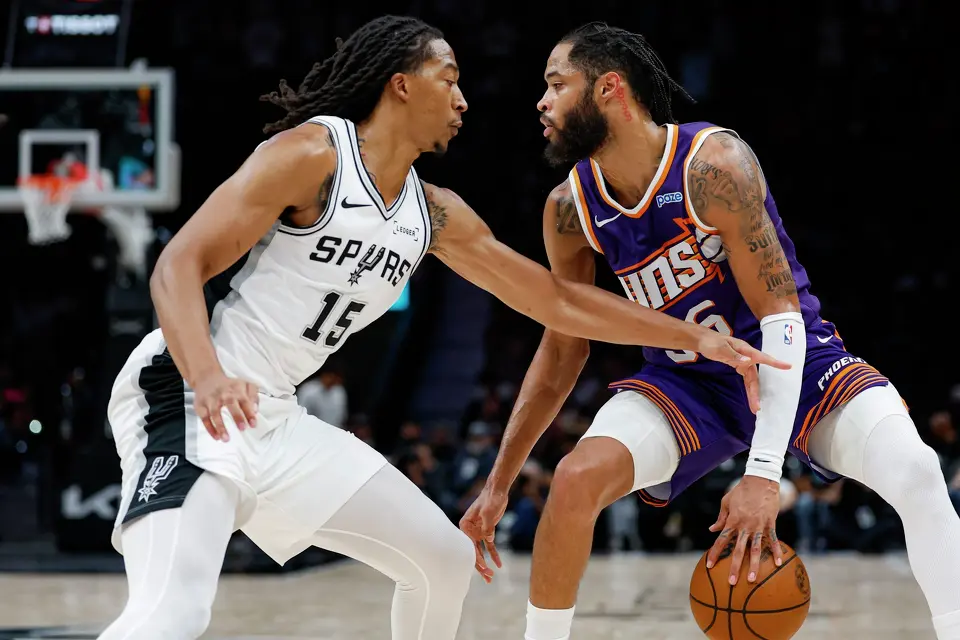 San Antonio Spurs forward Maliq Brown (15) guards Phoenix Suns forward Phillip Wheeler (36) during the second half of a preseason NBA game at Frost Bank Center in San Antonio, Wednesday, Oct. 14, 2026. The Spurs defeated the Suns 123-103.