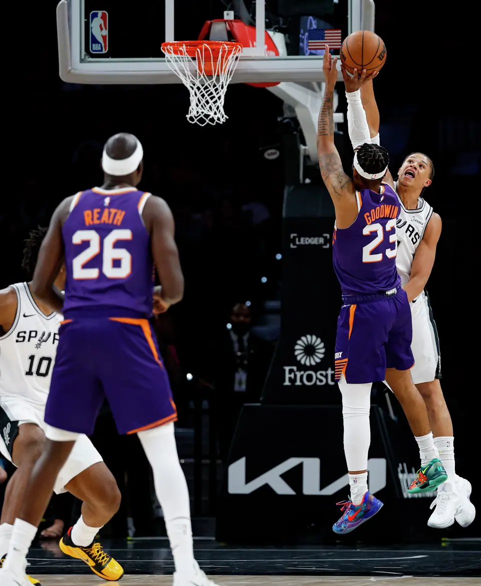 San Antonio Spurs forward Carter Bryant (11) blocks Phoenix Suns guard Jordan Goodwin (23) during the first half of a preseason NBA game at Frost Bank Center in San Antonio, Wednesday, Oct. 14, 2026.