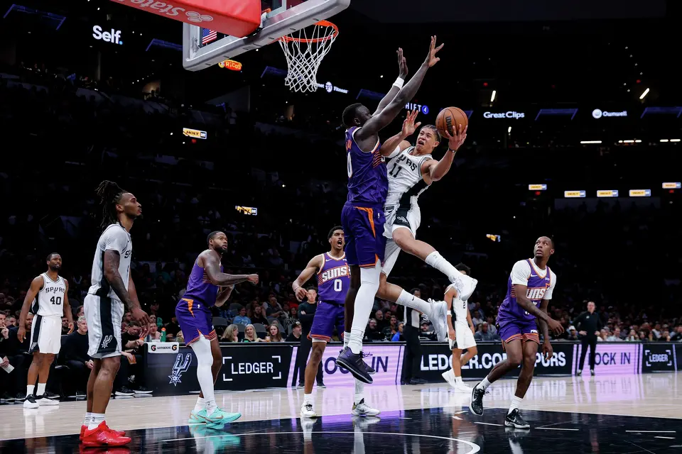 Phoenix Suns center Khaman Maluach (10) guards San Antonio Spurs forward Carter Bryant (11) as he goes up for a shot during the first half of a preseason NBA game at Frost Bank Center in San Antonio, Wednesday, Oct. 14, 2026.
