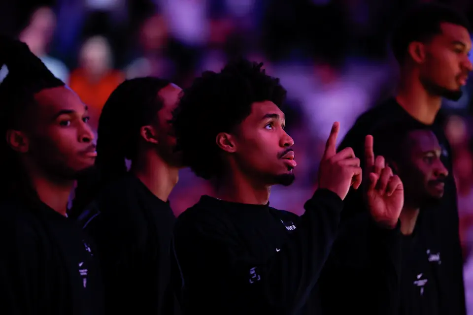San Antonio Spurs guard Dylan Harper (2) points to the sky as the National Anthem ends before taking on the Phoenix Suns during a preseason NBA game at Frost Bank Center in San Antonio, Wednesday, Oct. 14, 2026.